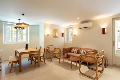a living room with a couch and a table and chairs at Modern Luxury Apartment 6 pax in Cannes