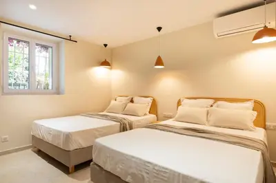 a bedroom with two beds and a window at Modern Luxury Apartment 6 pax in Cannes