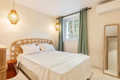a bedroom with a white bed with a window at Modern Luxury Apartment 6 pax in Cannes