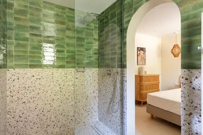 a bathroom with a shower with green tiles at Modern Luxury Apartment 6 pax in Cannes