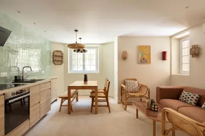 a kitchen and living room with a table and a couch at Modern Luxury Apartment 6 pax in Cannes