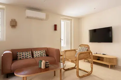 a living room with a couch and a tv at Modern Luxury Apartment 6 pax in Cannes