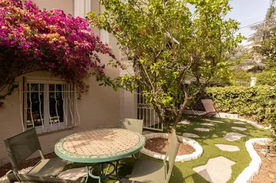 a table and chairs and a tree in a yard at Modern Luxury Apartment 6 pax in Cannes