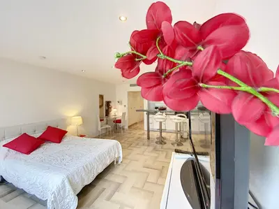a bedroom with a bed and a large pink flower at Gray d Albion THI235 in Cannes
