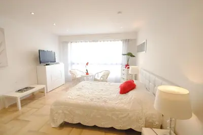 a bedroom with a bed with a red pillow on it at Gray d Albion THI235 in Cannes