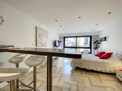 a bedroom with a bed and a dining table and chairs at Gray d Albion THI235 in Cannes