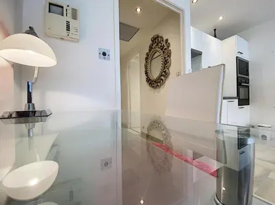 a white bathroom with a toilet and a mirror at Gray d Albion THI235 in Cannes