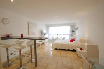 a bedroom with a bed and a desk in a room at Gray d Albion THI235 in Cannes