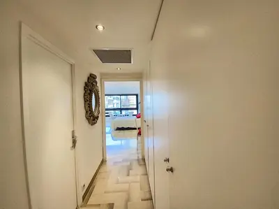 a hallway with a white door and a room with a hallway at Gray d Albion THI235 in Cannes
