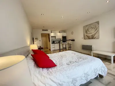 a bedroom with a large white bed with red pillows at Gray d Albion THI235 in Cannes