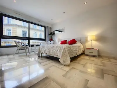 a bedroom with a bed with red pillows and a table at Gray d Albion THI235 in Cannes