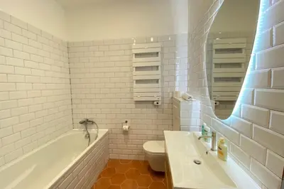 a bathroom with a tub and a toilet and a sink at New apartment in Forville with balcony in Cannes