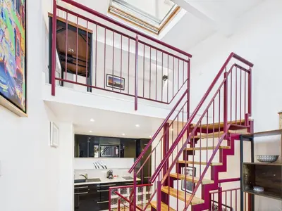 a staircase with red railings in a house at LE CHARMANT sublime Maison de Ville dans le Suquet au calme in Cannes