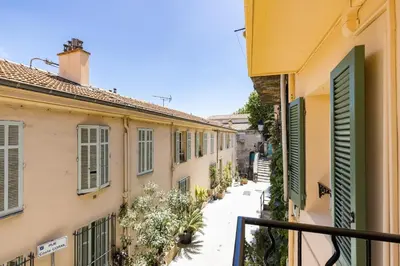 a view of an alley between two buildings at LE CHARMANT sublime Maison de Ville dans le Suquet au calme in Cannes