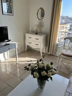 a living room with a vase of flowers on a table at Cannes, Croisette, Palais Miramar in Cannes