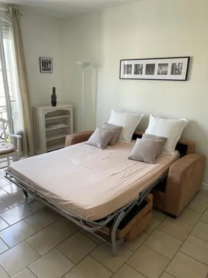 a large bed sitting in a room with at Cannes, Croisette, Palais Miramar in Cannes