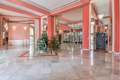 a lobby with two christmas trees in the middle at Appartement Miramar Cannes Croisette in Cannes