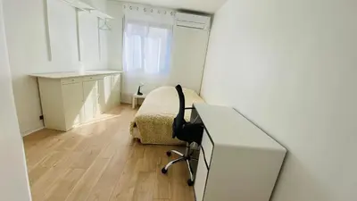 a white bedroom with a desk and a bed at Cosy 3pièces à 5min de la plage in Cannes