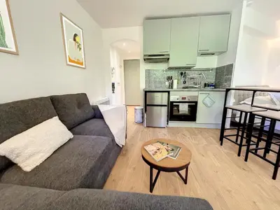 a living room with a couch and a table at Appartement cosy au centre de Cannes in Cannes
