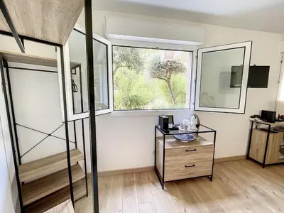 a room with a bed and a window and a dresser at Appartement cosy au centre de Cannes in Cannes