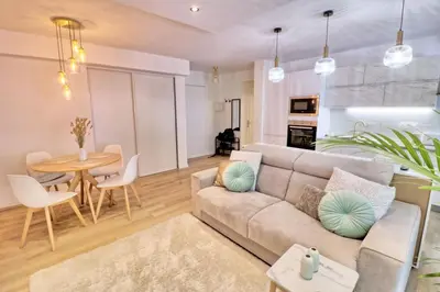 a living room with a couch and a table at Ref FLEUR - Palmes d'Or Properties in Cannes