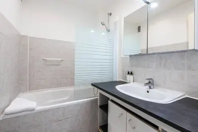 a bathroom with a tub and a sink and a bath tub at Cannes Branly :2BDR Apartment in Cannes