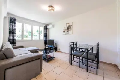 a living room with a couch and a table at Cannes Branly :2BDR Apartment in Cannes
