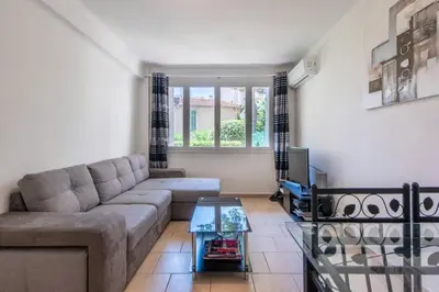 a living room with a couch and a glass table at Cannes Branly :2BDR Apartment in Cannes