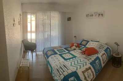 a bedroom with a bed with a teddy bear on it at Lovely cosy nest close to the centre of Cannes in Cannes