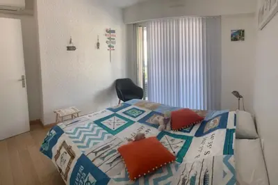 a bedroom with a dog laying on a bed at Lovely cosy nest close to the centre of Cannes in Cannes