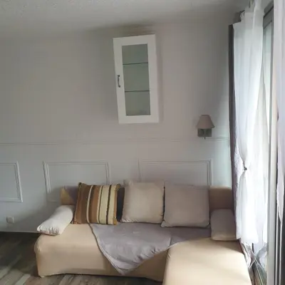 a couch in a living room with a mirror at Appartement 172 in Cannes