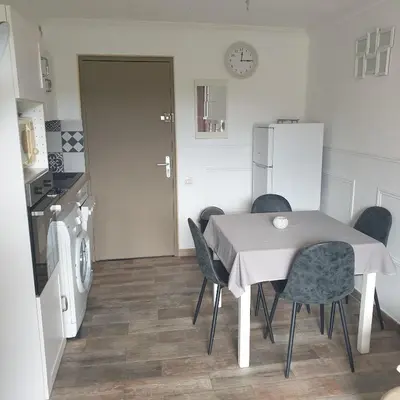 a kitchen with a table and chairs in a kitchen at Appartement 172 in Cannes