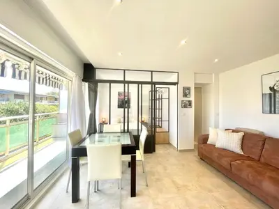 a living room with a table and a couch at Copacabana beach, by Welcome to Cannes in Cannes