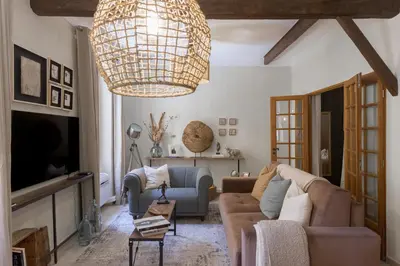 a living room with a couch and a chandelier at 
