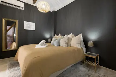 a bedroom with a large bed and a mirror at 