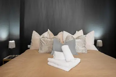 a large bed with pillows and towels on it at 