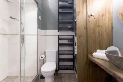 a bathroom with a toilet and a shower and a sink at 