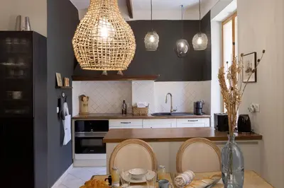 a kitchen with a table with chairs and aendant light at 