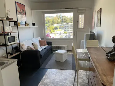 a living room with a couch and a window at Studio in Cannes