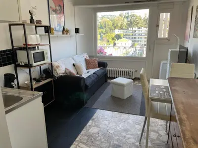 a living room with a couch and a window at Studio in Cannes