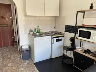 a small kitchen with a sink and a microwave at Studio in Cannes