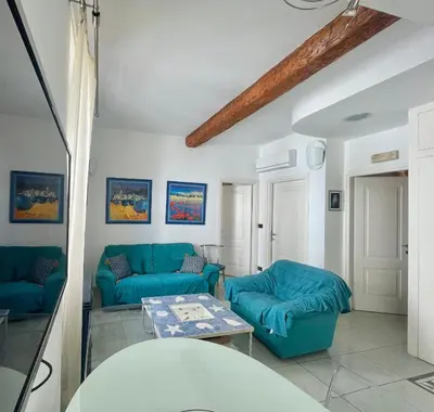 a living room with blue couches and a table at 50 Mètres du Palais by Connexion in Cannes