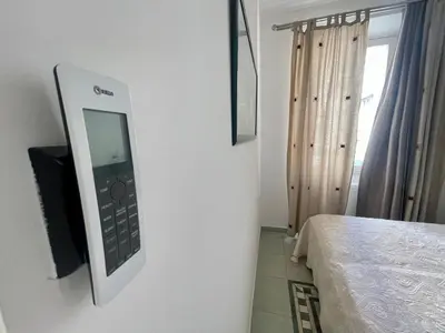 a remote control on the wall of a bedroom at 50 Mètres du Palais by Connexion in Cannes