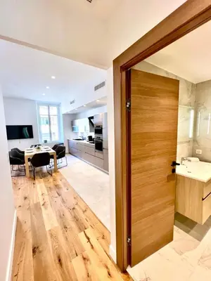 a door leading to a kitchen and a dining room at L'Elégance Rue d'Antibes - Palais & Plages - 200 m Croisette - Parking privé - Clim - Wifi in Cannes