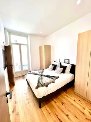 a bedroom with a large bed in a room at L'Elégance Rue d'Antibes - Palais & Plages - 200 m Croisette - Parking privé - Clim - Wifi in Cannes