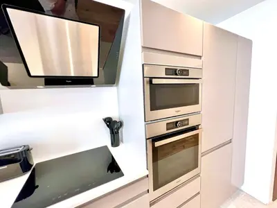 a kitchen with two ovens and a sink at L'Elégance Rue d'Antibes - Palais & Plages - 200 m Croisette - Parking privé - Clim - Wifi in Cannes