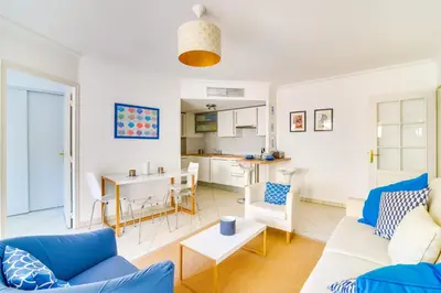 a living room with a couch and a table at Parc RL Perfect 1 bedroom apartment next to beaches and shops in Cannes