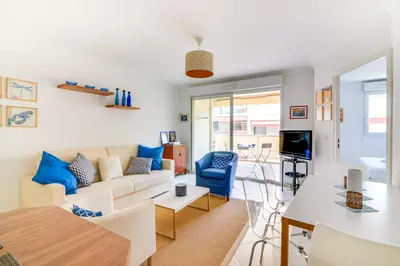 a living room with a couch and a table at Parc RL Perfect 1 bedroom apartment next to beaches and shops in Cannes