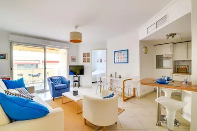 a living room with a couch and a table at Parc RL Perfect 1 bedroom apartment next to beaches and shops in Cannes
