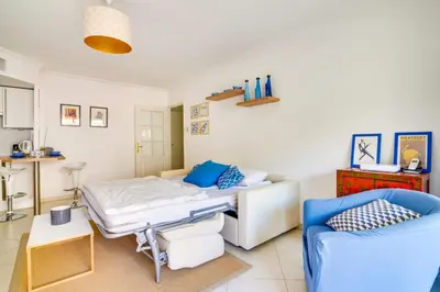 a hospital room with a bed and a couch at Parc RL Perfect 1 bedroom apartment next to beaches and shops in Cannes